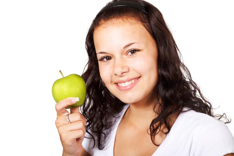 Healthy woman eating an apple